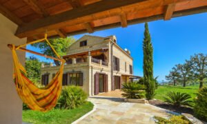 Italian Hillside Real Estate – Beautiful farmhouse with sea views near Lapedona, Le Marche, featuring spacious living areas, a pool, and picturesque surroundings.