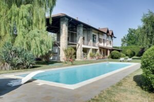 Elegant restored villa nestled in the rolling hills near Acqui Terme, surrounded by lush greenery and a serene private park