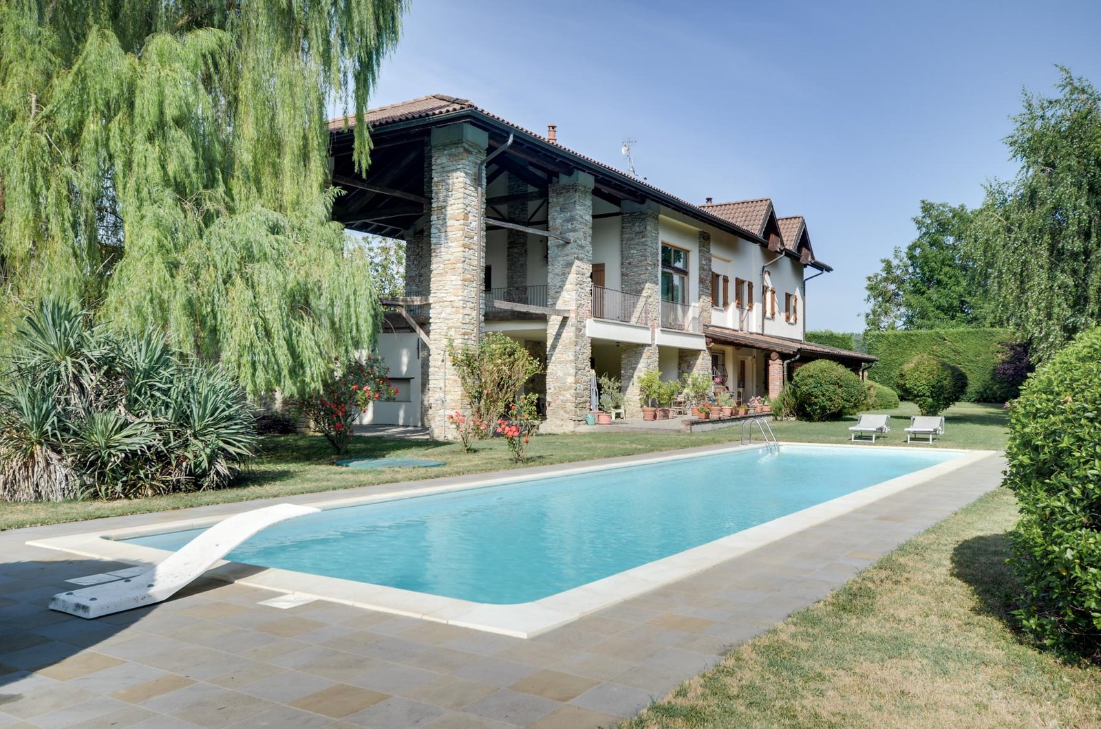 Elegant restored villa nestled in the rolling hills near Acqui Terme, surrounded by lush greenery and a serene private park